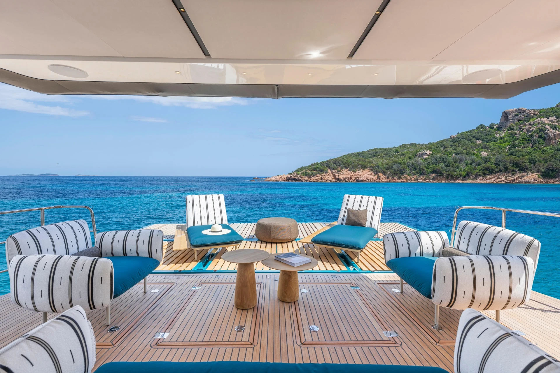 Spacious Lagoon Eigthy2 deck lounge with teak flooring and turquoise Mediterranean waters