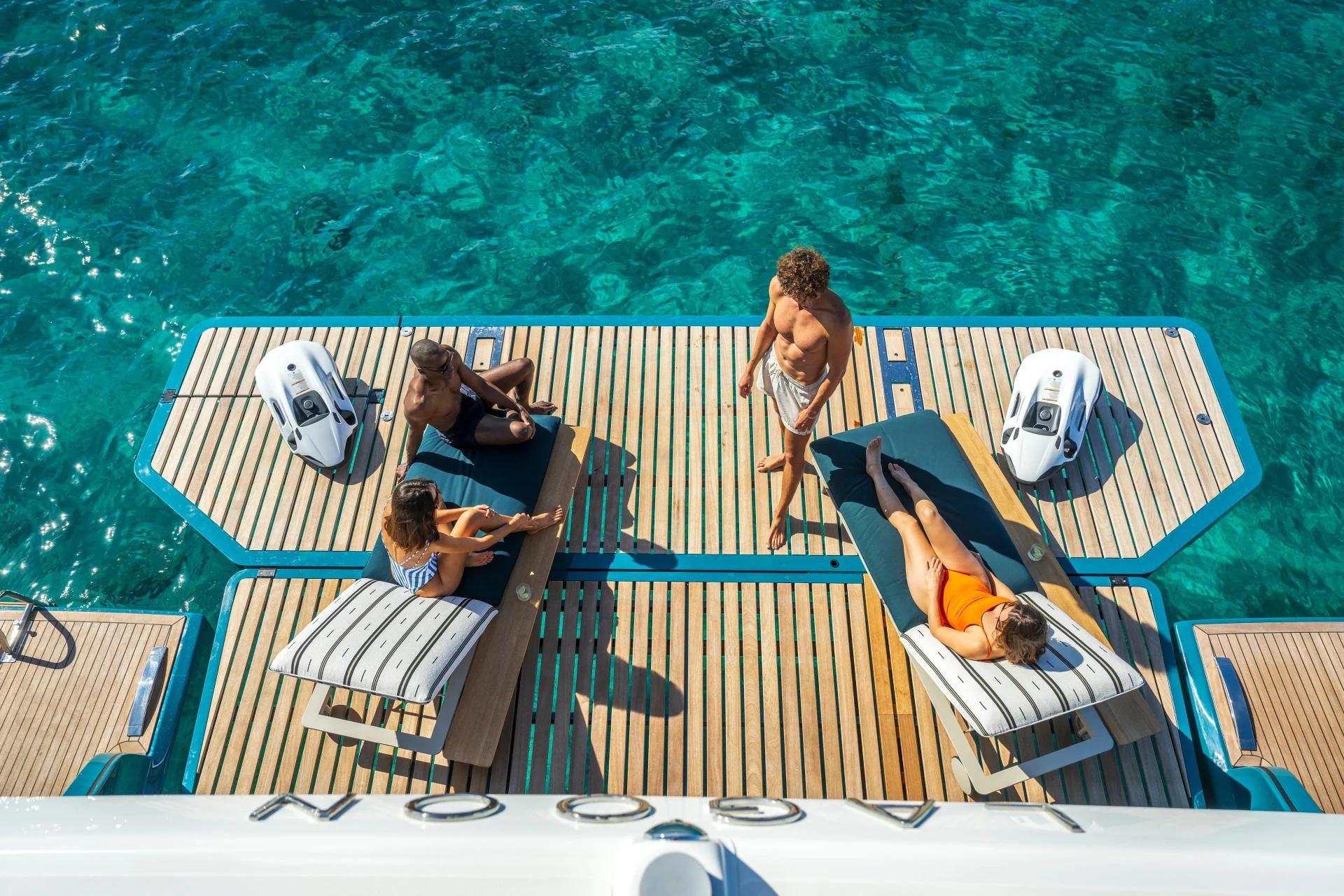 Aerial view of guests on the swim platform of the Lagoon Eigthy2 above clear turquoise water